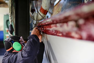 Worker fixing a boat