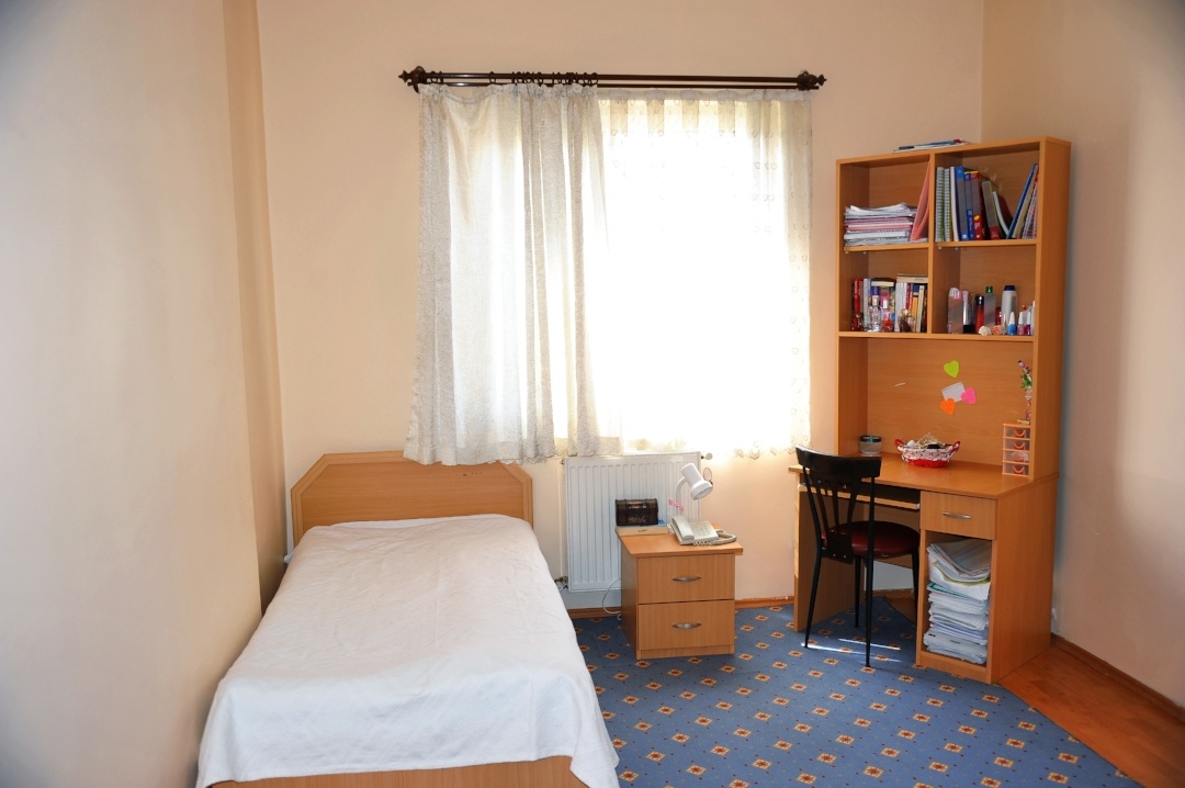College dorm room with bed covered with antimicrobial fabric